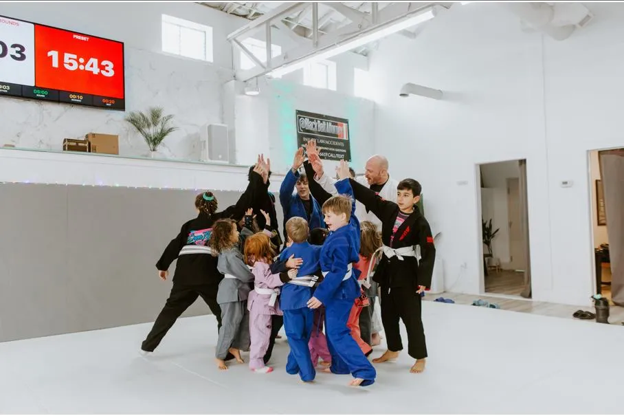 Kids practicing Brazilian Jiu-Jitsu techniques in class.