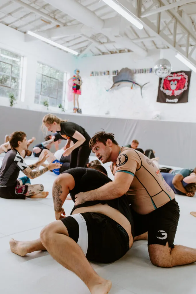Two students are sparring during a self-defense focused class at SuperFly BJJ in Decatur, GA.