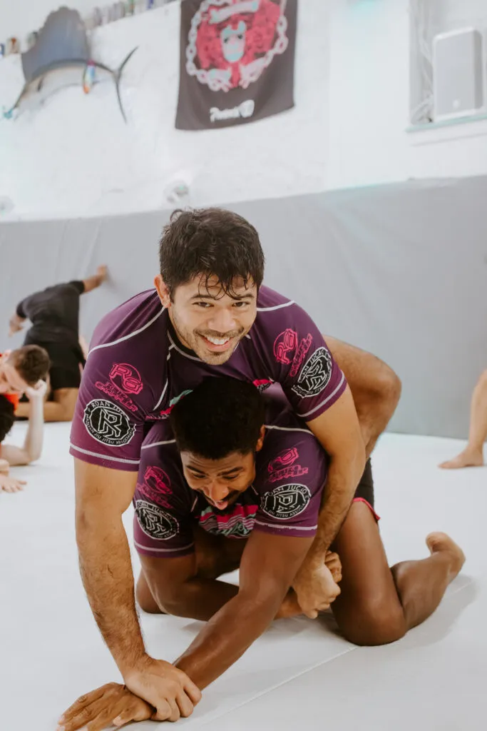 Two students have a fun time practicing martial arts in Decatur at SuperFly BJJ.