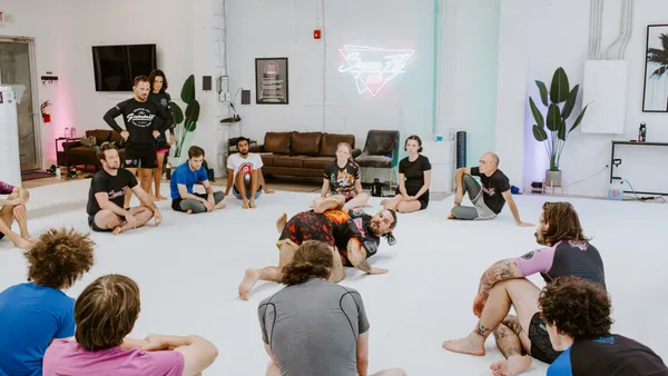 An instructor demonstrating technique to the competition training class