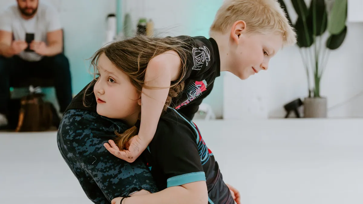Two kids sparring during the Kids 7+ BJJ class at SuperFly BJJ in Decatur, GA