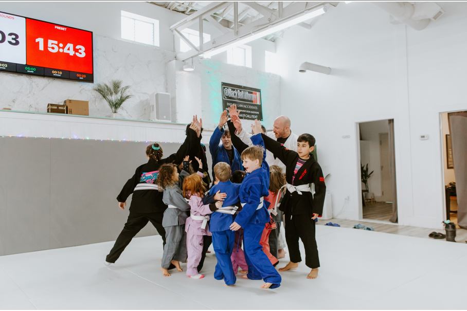 Kids practicing Brazilian Jiu-Jitsu techniques in class.