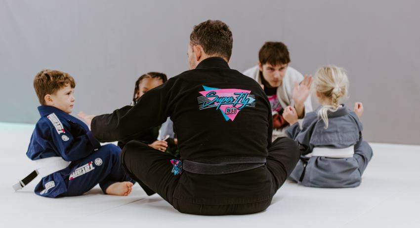 Young student staying calm while practicing Brazilian Jiu-Jitsu.