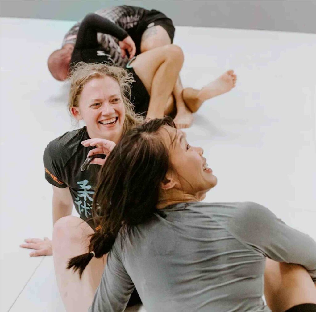 Women practicing Brazilian Jiu-Jitsu in a safe, encouraging space.