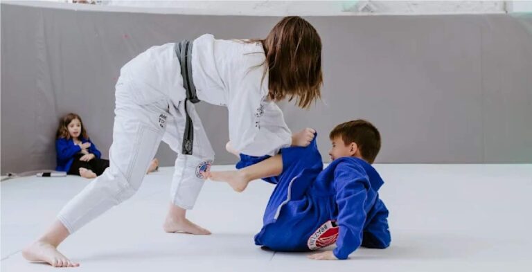 Kids training together in a fun Halloween-themed BJJ class.