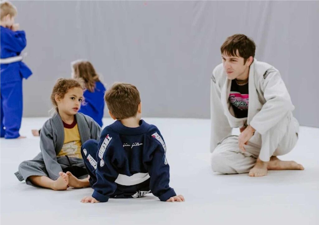 Child practicing Brazilian Jiu-Jitsu with focus and control.