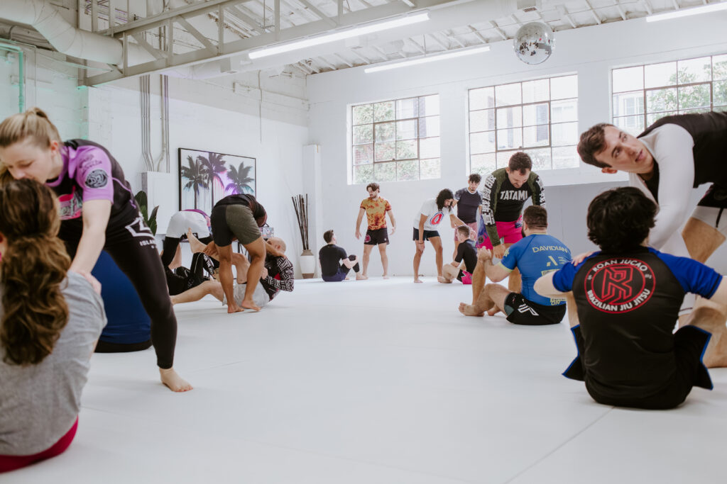 Students practicing no-gi BJJ fundamentals during a partner drilling portion of the Fundamentals class at SuperFly BJJ Decatur.
