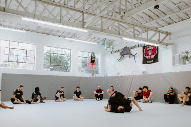 A BJJ instructor demonstrating a BJJ technique to his students during the BJJ Fundamentals class at SuperFly BHJJ