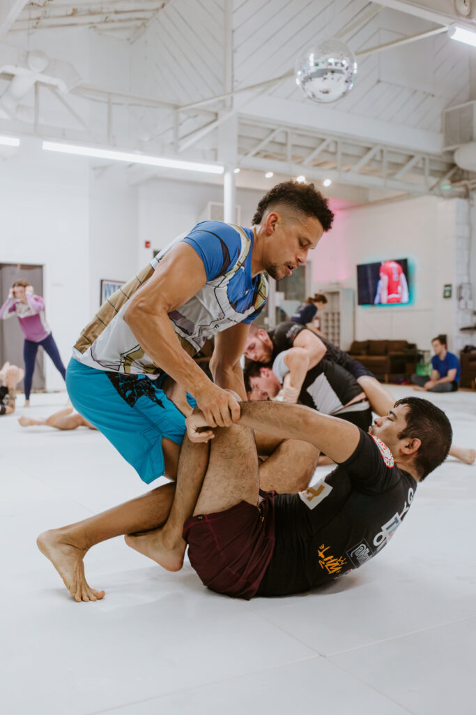Two no-gi BJJ athletes sparring during the adult intermediate/advanced no-gi bjj class at SuperFly BJJ in Decatur.