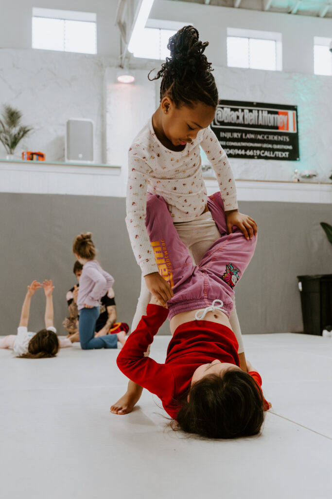 Two children practicing Brazilian Jiu-Jitsu in the Kids 4-6 year old BJJ class at SuperFly BJJ in Decatur, GA