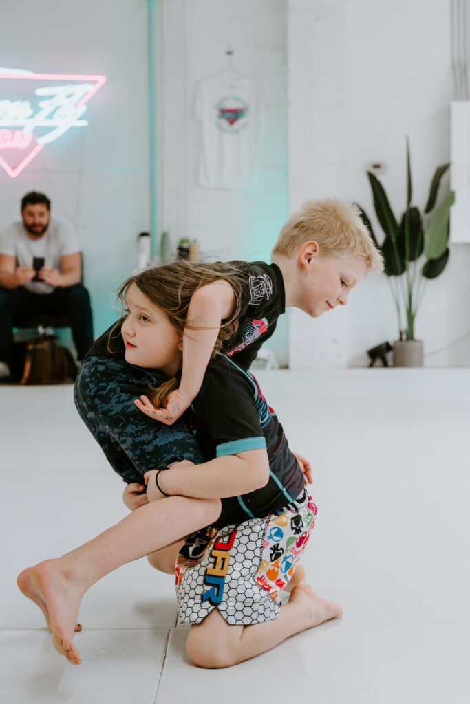 Two students sparring during the Kids 7+ BJJ class at SuperFly BJJ Decatur
