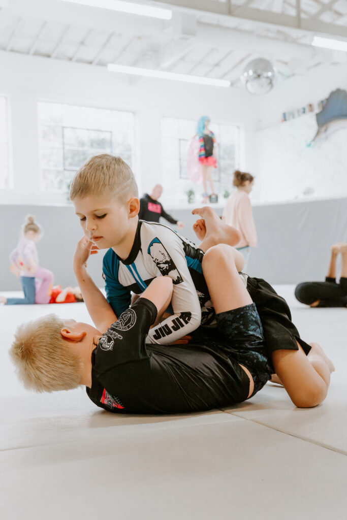Two kids sparring during the Kids 7+ No-Gi BJJ class at SuperFly BJJ Decatur