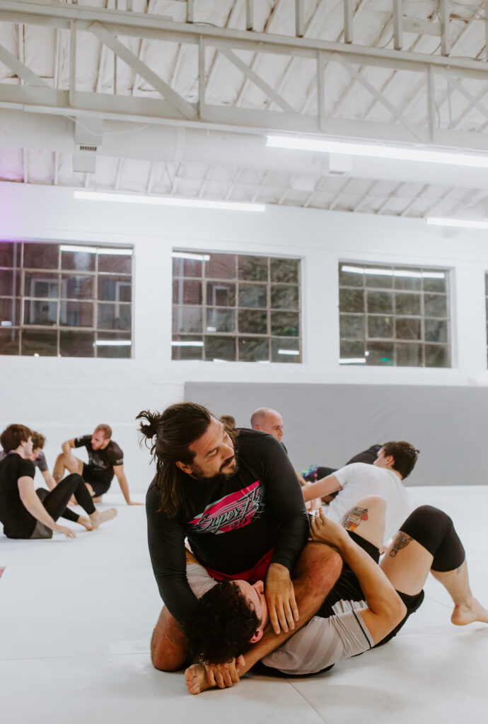 Two adult students sparring during an adult intermediate/advanced class at SuperFly BJJ.