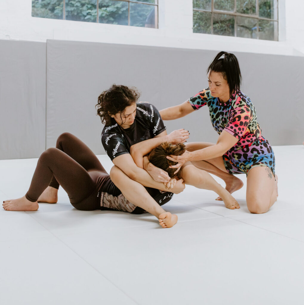 Women practicing martial arts for women in a martial arts class at SuperFly BJJ in Decatur.