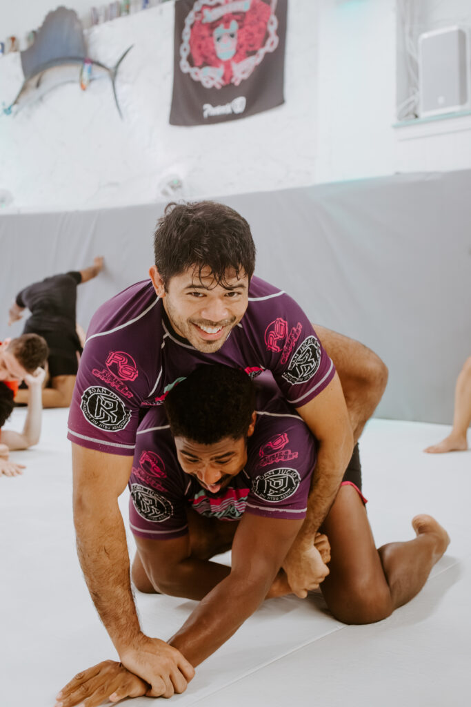 Two students have a fun time practicing martial arts in Decatur at SuperFly BJJ.