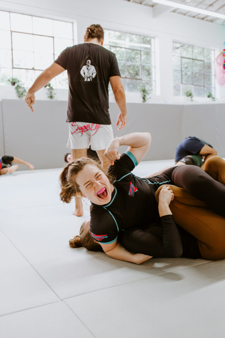 Two students having fun while training martial arts in Decatur after work at SuperFly BJJ.